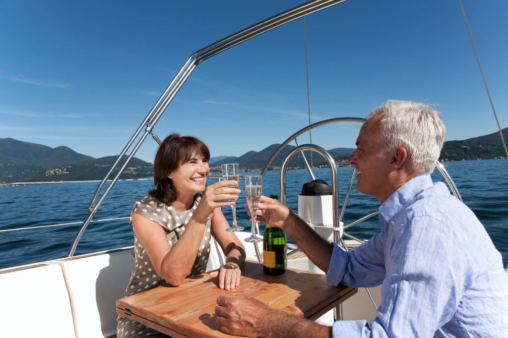 Older couple having champagne on boat